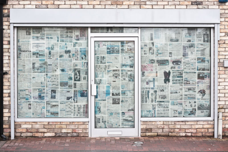 image of store front covered in newspapers